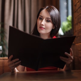 person reading menu at restaurant