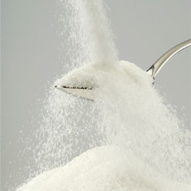 picture of sugar overflowing in spoon
