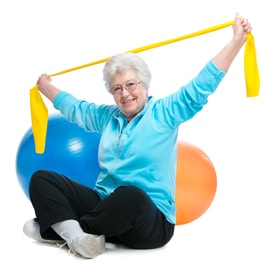older woman exercising with theratubes and exercise balls