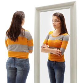 person looking at self in mirror imagining thinner self