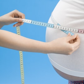 large abdomen being measured