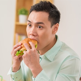 stunned male eating burger