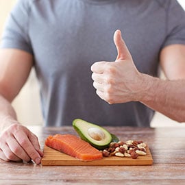 man with healthy foods giving thumbs up