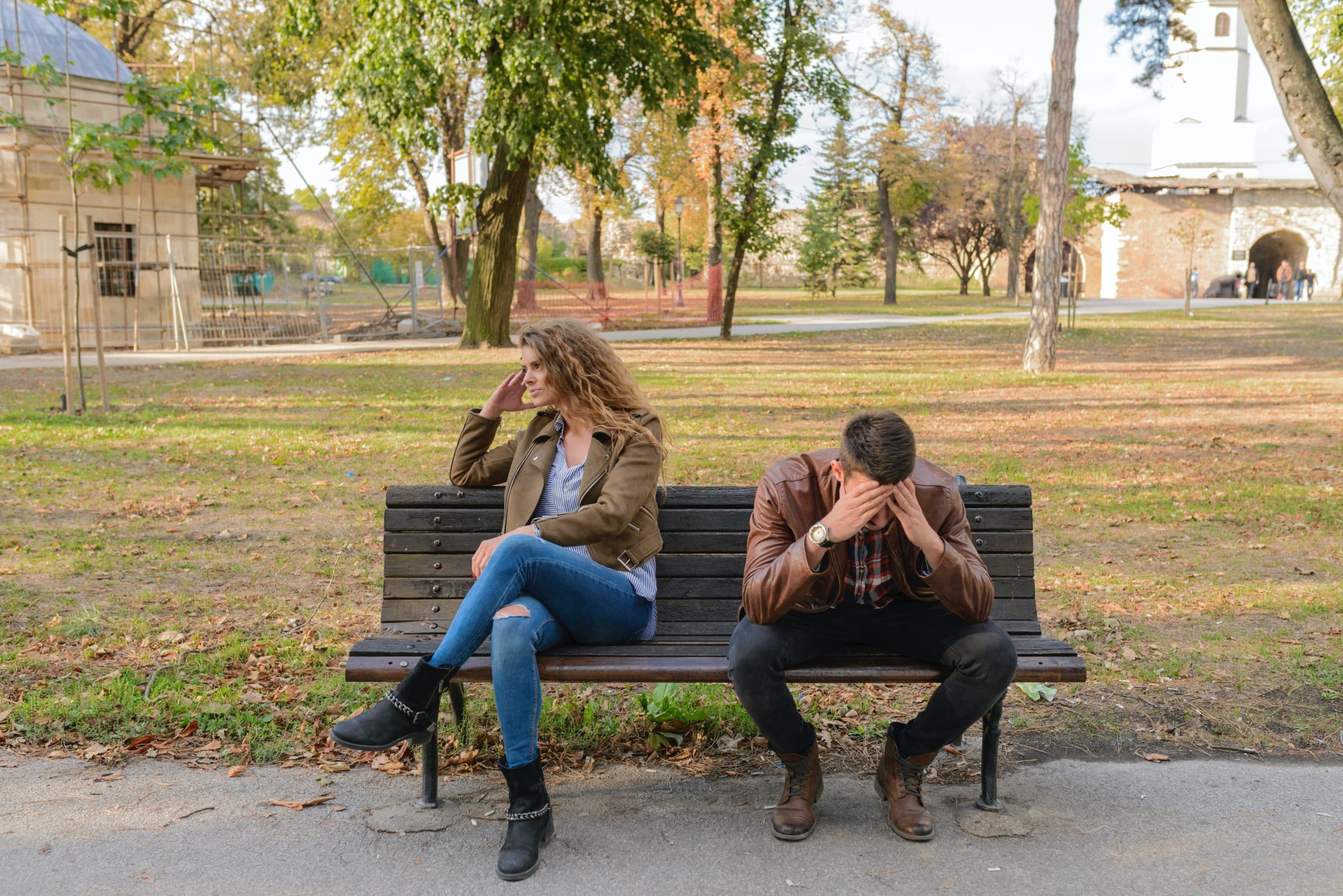 stressed couple sitting on bench